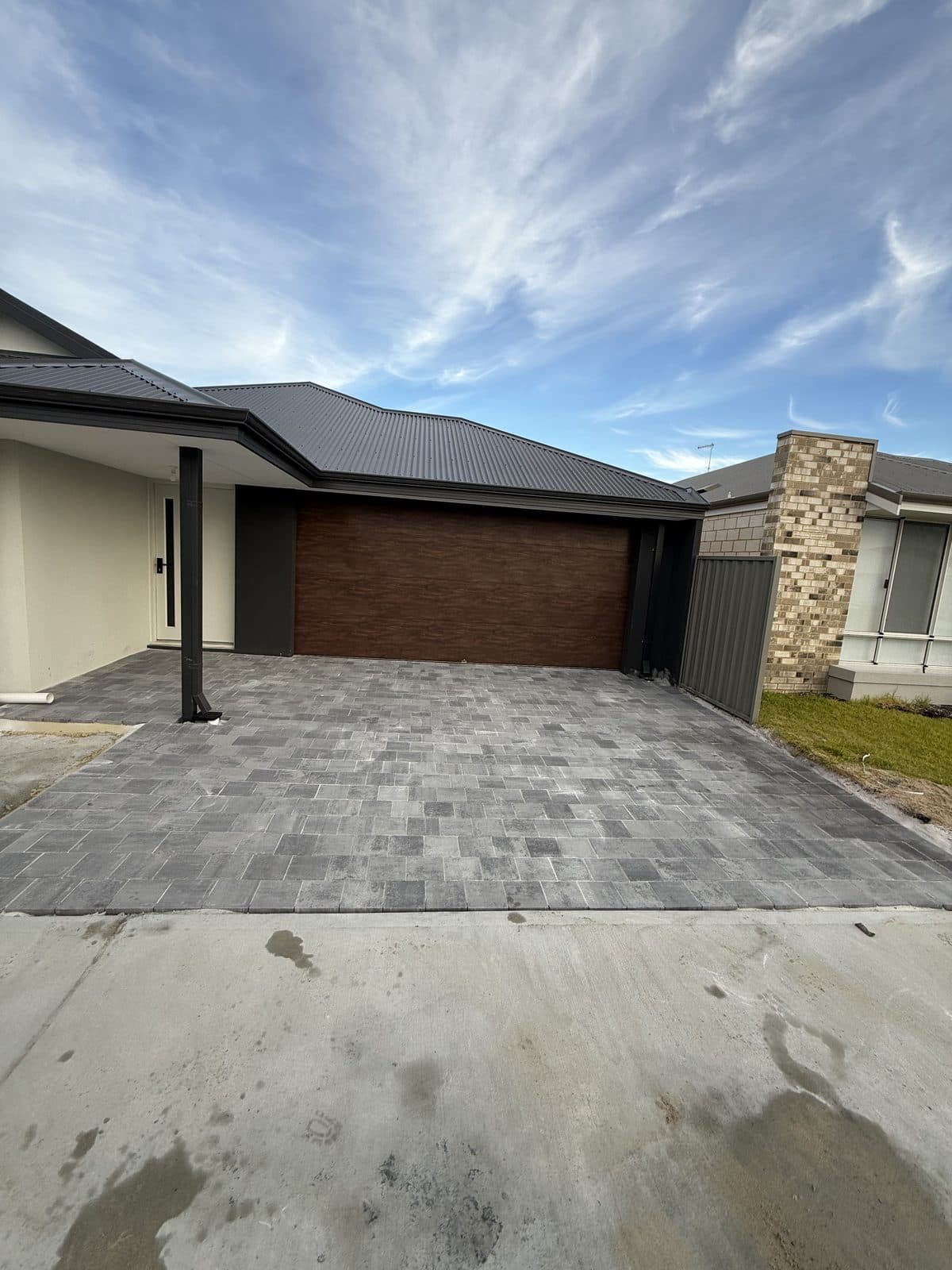 Grey block-paved driveway in front of a double garage, Perth