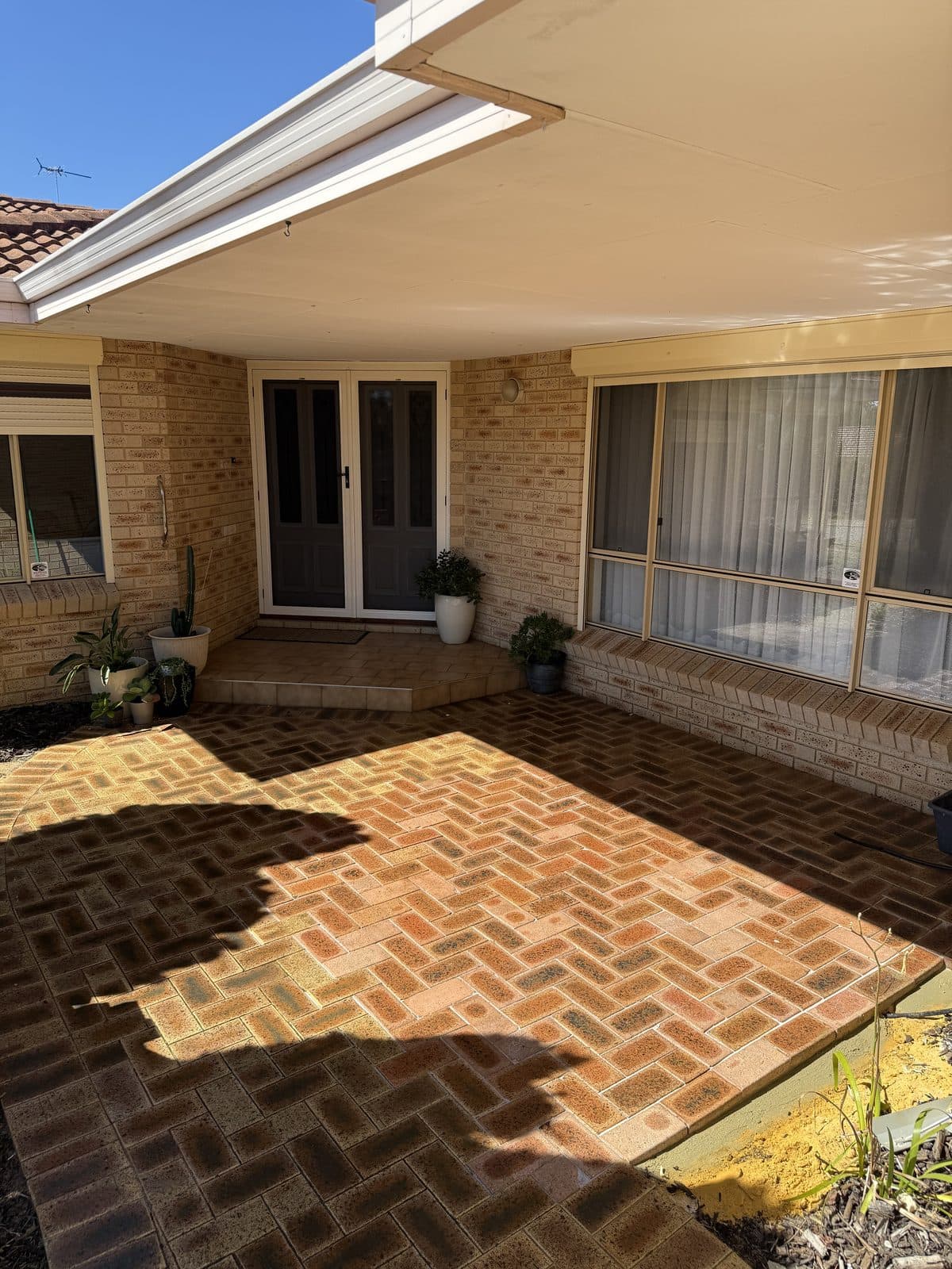 Restored red herringbone brick paving in a courtyard, Perth