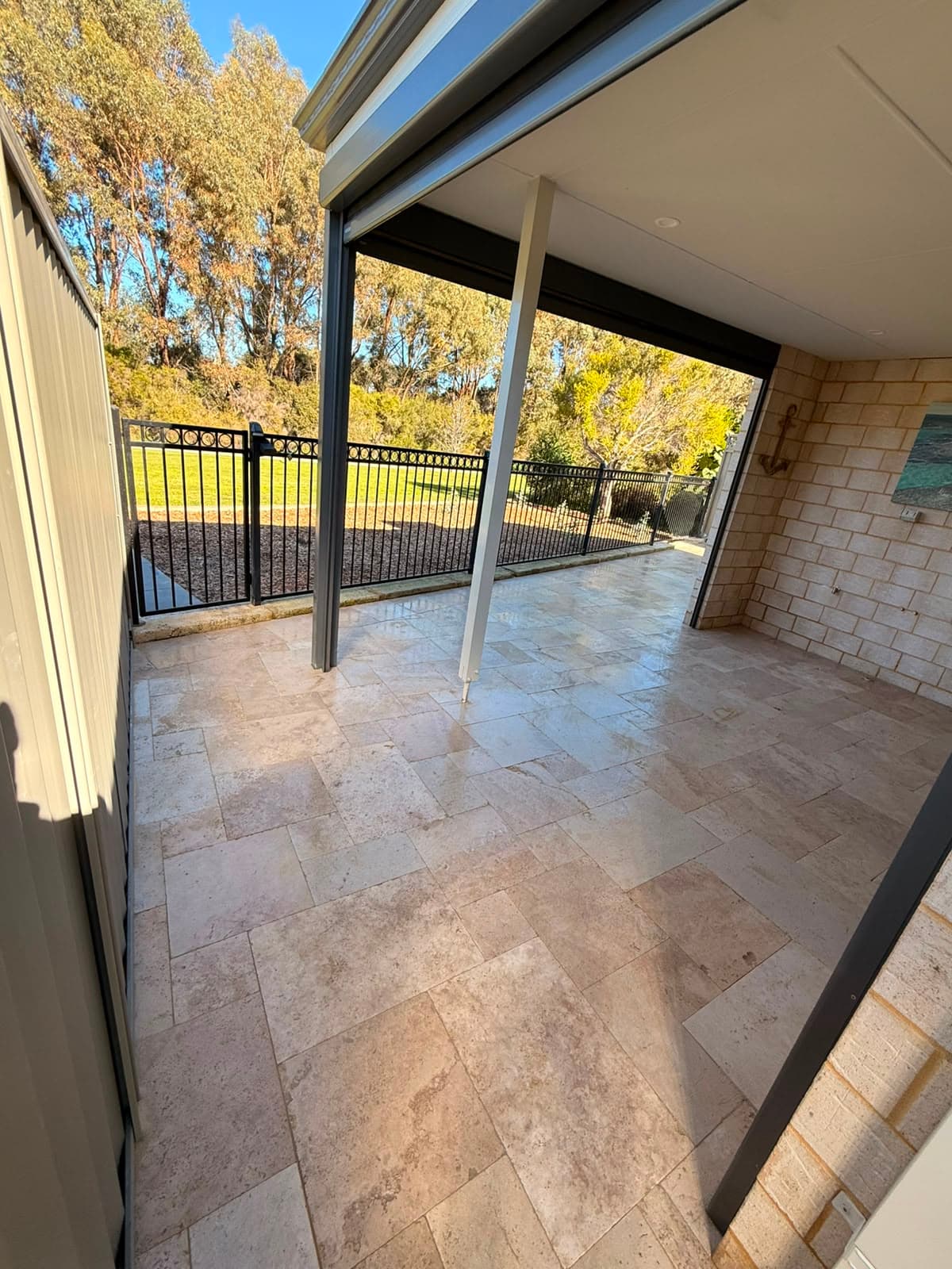 Travertine paving under a covered alfresco looking onto a Perth garden