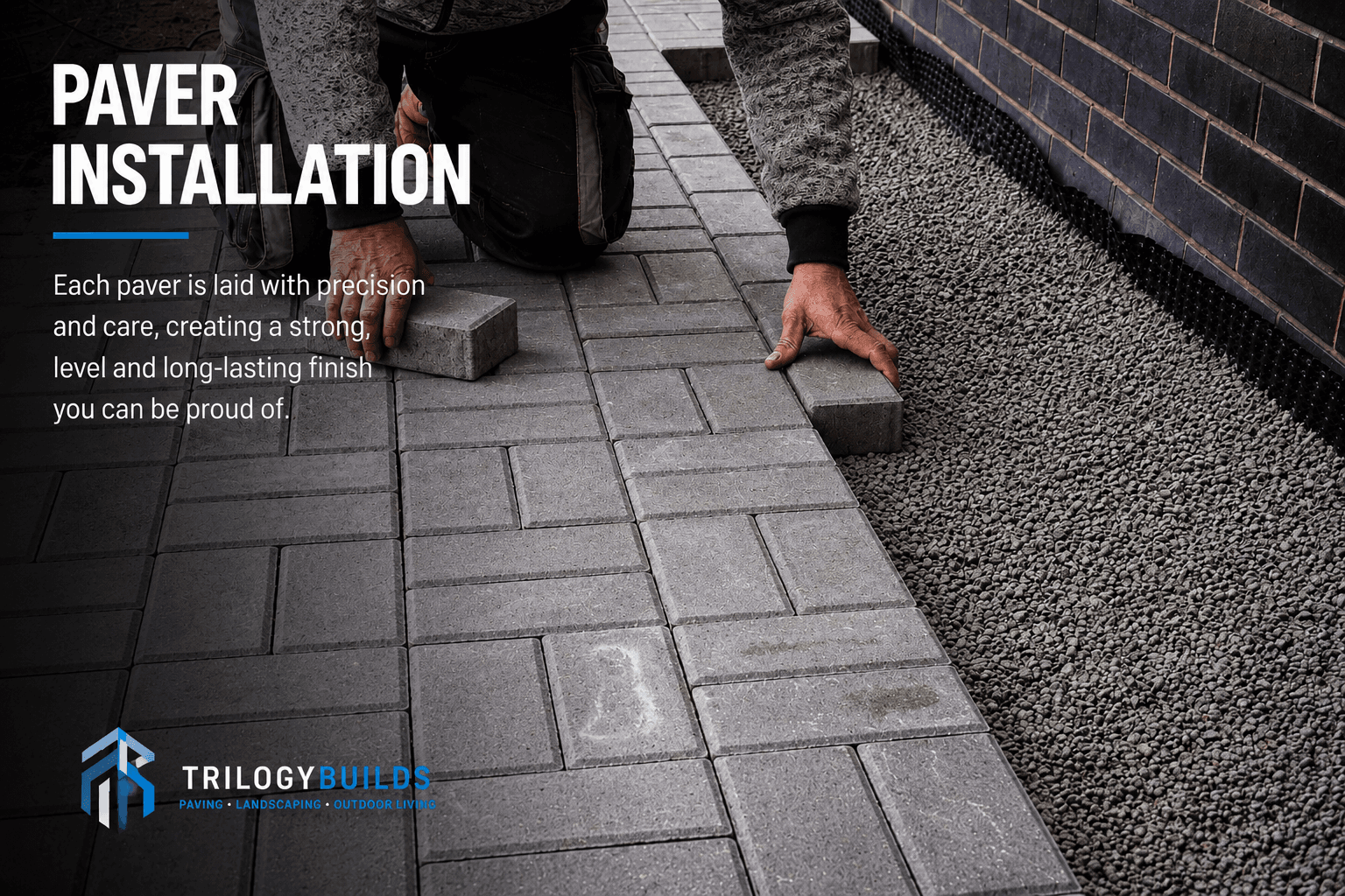 Paver installation — grey concrete pavers laid by hand against a straight edge course