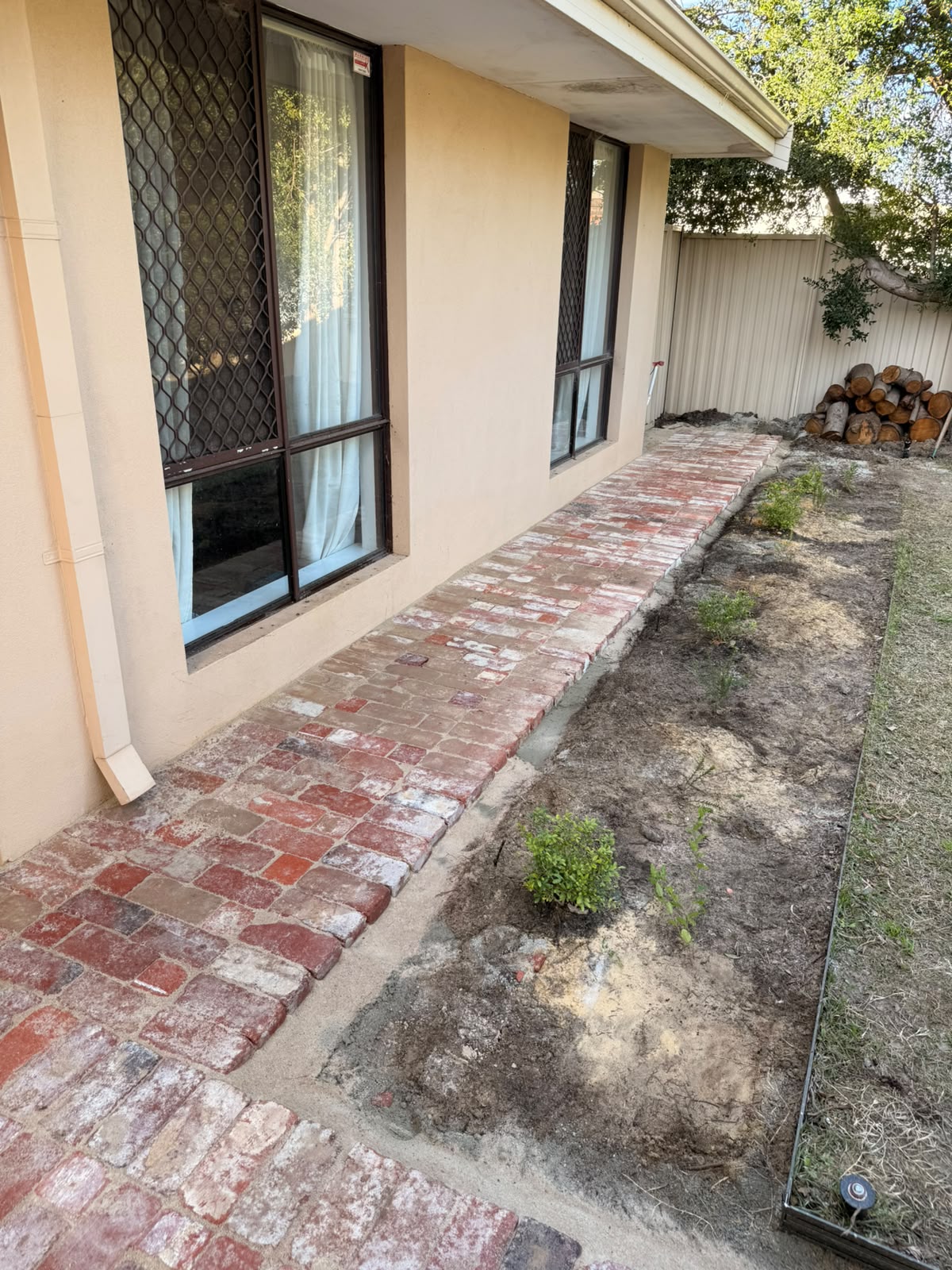 Red brick paver pathway running along the side of a Perth house