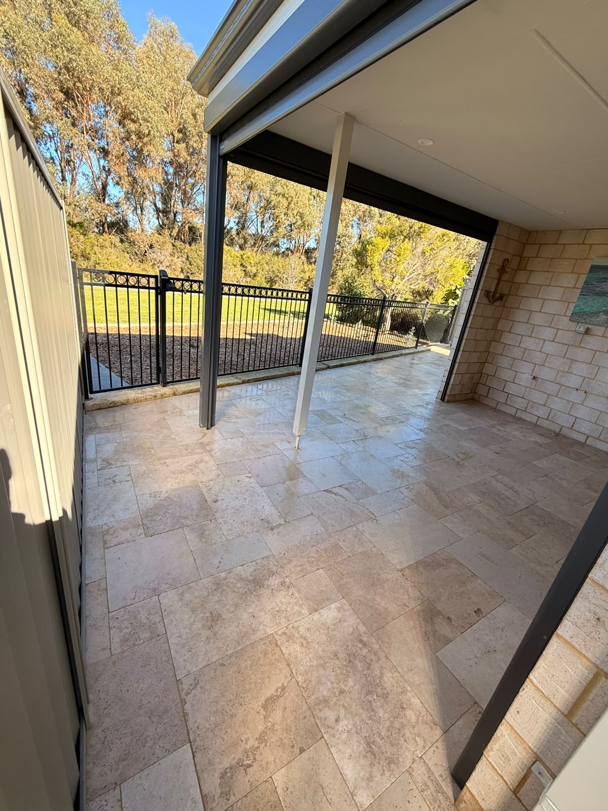 Travertine paving under a covered alfresco looking onto a Perth garden